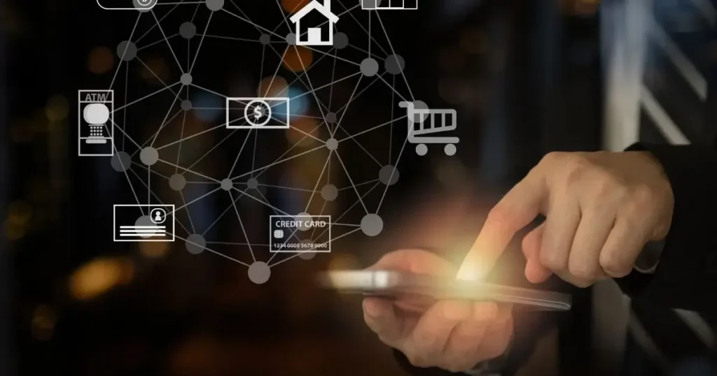 Several interconnected  icons are showing while a man's hand pressing on the dell phone , reflecting mobile marketing