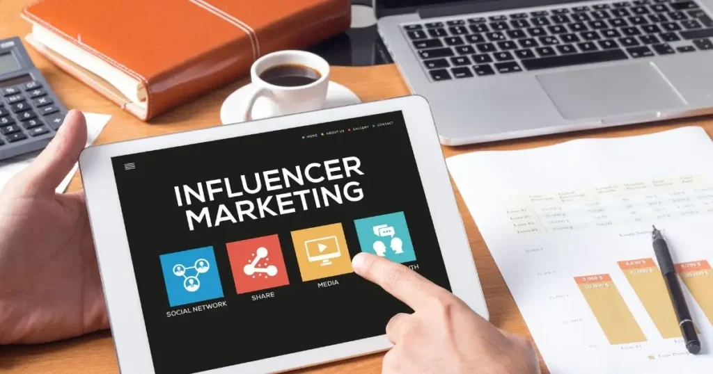 A hand is pressing on a box where Influencer Marketing is written above